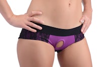 a woman wearing a purple and black pantyhose with a hole in the middle