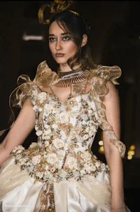 a woman in a gold dress posing for a photo