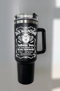 a black travel mug with a black label and a straw