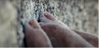 a person's finger on a rock
