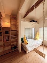a bed in a room with a swing