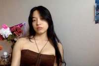a young woman in a brown dress posing for a picture