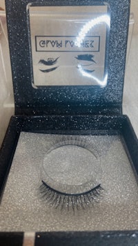a box of false eyelashes in a black box