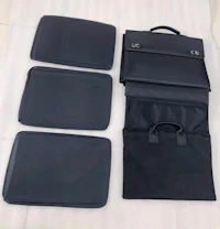 four black briefcases on a white bed