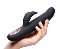 a woman's hand holding a black sex toy