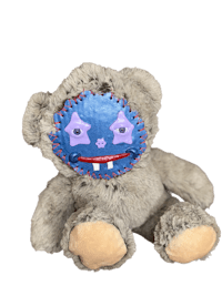 a teddy bear with a blue and purple face