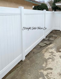 a white vinyl fence in a backyard