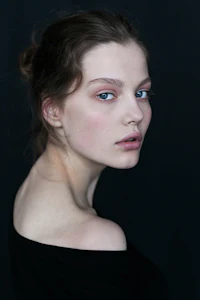 a woman with blue eyes is posing for a photo