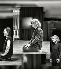 a black and white photo of a group of people sitting on the floor