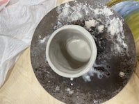a bowl is being made on a pottery wheel