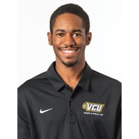 a young man wearing a black nike polo