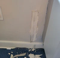 a room with a wall that has been torn down