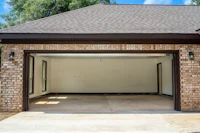 a garage with a brick wall and a door