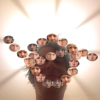 a man's head surrounded by many circles