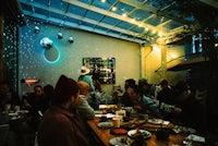 a group of people sitting around a table at a restaurant