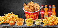 a tray with fried chicken, fries and soda