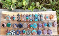 a group of colorful pendants on a wooden board