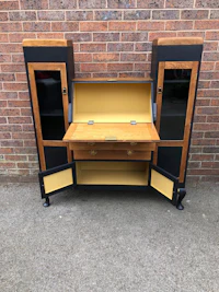 a black and gold desk with drawers and doors