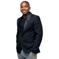 a man in a black blazer and gray pants posing for a photo