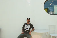 a man on a skateboard sitting on a chair