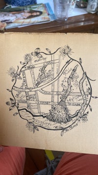 a person is holding up a map of a city