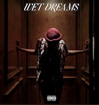 a man in a red hat standing in a hallway with the words wet dreams