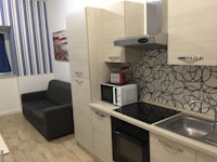 a small kitchen with a stove and microwave