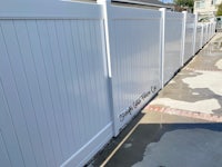 a white vinyl fence in a residential area