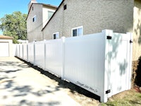 a white fence in front of a house