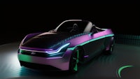 a futuristic electric car is shown in a dark room