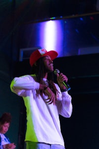 a man with dreadlocks is holding a microphone
