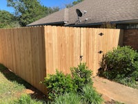 a wooden fence in front of a house