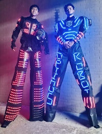 two people standing next to each other in a brightly lit outfit