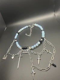 a bracelet with silver and blue beads and a sword