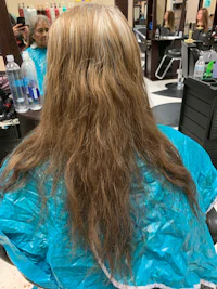 a woman is getting her hair done in a salon