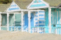 a painting of beach huts in the sand