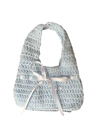 a blue crocheted bib with a white bow