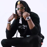 a man wearing a black hoodie and sunglasses