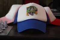 a hat with an elephant on it sits on top of a chess board