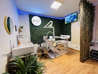 a dentist's office with plants and a tv