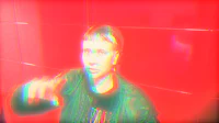 a man is pointing at a red wall