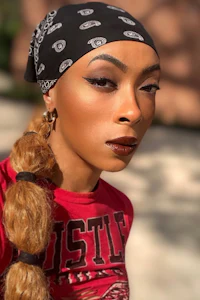a woman wearing a bandana and a t - shirt