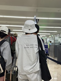 a group of people standing in line at an airport