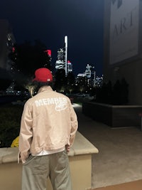 a man standing in front of a building at night