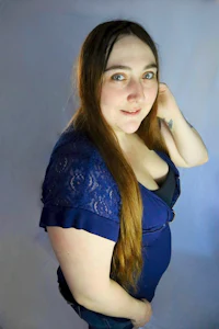 a woman with long hair posing for a photo