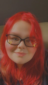 a woman with red hair and glasses