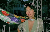 a woman wearing sunglasses and a scarf