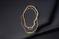 a gold plated necklace with a name written on it
