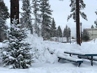 a blue picnic table covered in snow