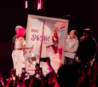 a group of people holding up a framed picture of rihanna